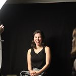 Student laughs getting portrait taken.