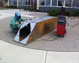 Welding a sculpture outdoors