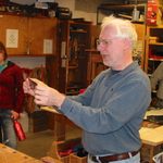 Tom Caspar showing students techniques of woodworking.