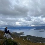 Elena Parkerson ‘25 perches on a rock overlooking Lake Pedder in the Tasmanian World Heritage Wilderness Area