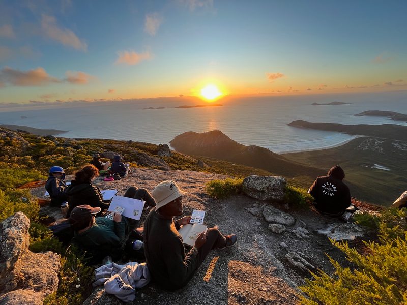 Ethan Cline-Cole ‘25 and other students draw the sunset on Mt. Oberon in Wilsons Promontory National Park