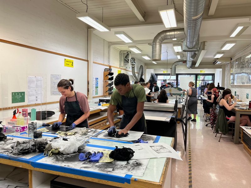 Katrin Birk ‘25 and Ethan Cline-Cole ‘25 prepare their intaglio plates to run through the printing press