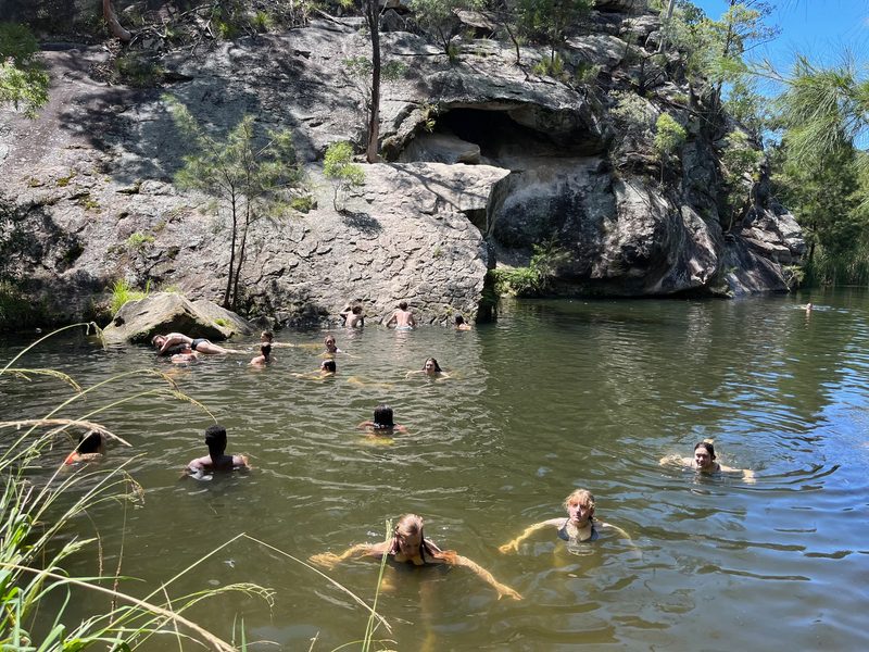 Students join professor Eleanor Jensen ‘01 to cool off from the summer sun with a refreshing dip in the rock pools at Canarvon Gorge