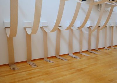 Emmett Ramstad: Parade, paper towel dispensers, paper toweling, 2023, dimensions variable.