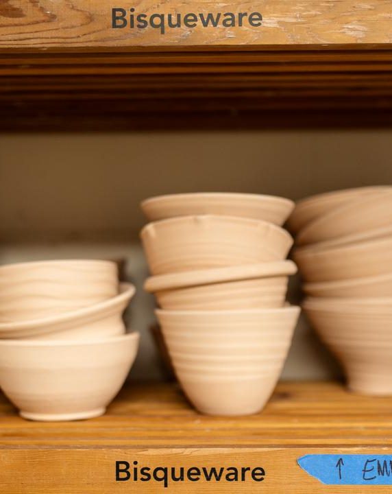 Stacked bowls on a shelf that have been bisquefired