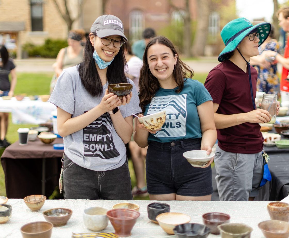 Student ceramicists helping with bowl selection at Empty Bowls