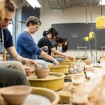 Several students and staff members throwing bowls for Empty Bowls
