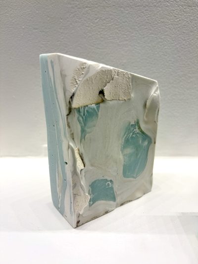 Upright chunk of ceramic with pale blue and white glazes