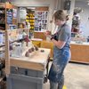 student standing at a bench dividing clay into equal portions