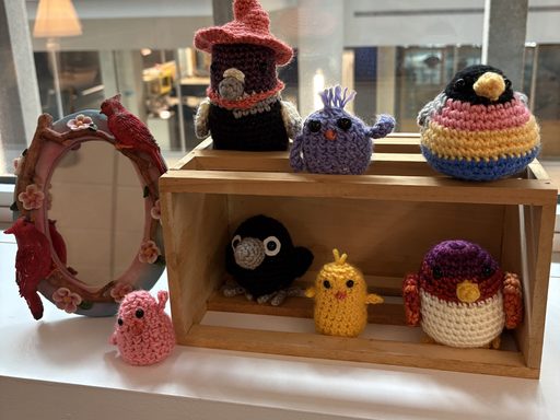 knitted birds on a window sill