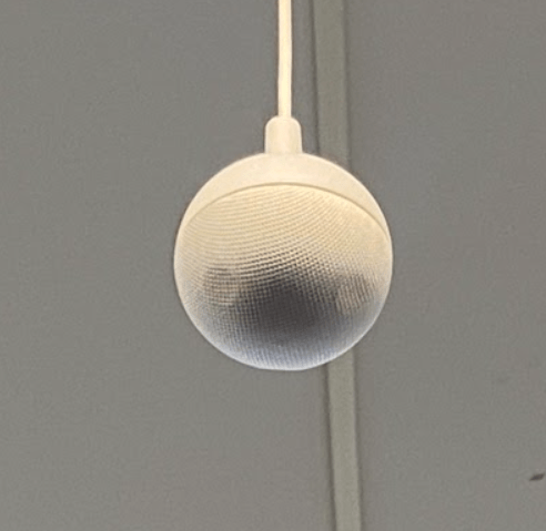 Vaddio brand spherical microphone hanging from ceiling.