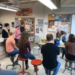 Ehren Tool's Ceramic Workshop. Students and faculty watch Tool as he shapes a cup and talks to them.
