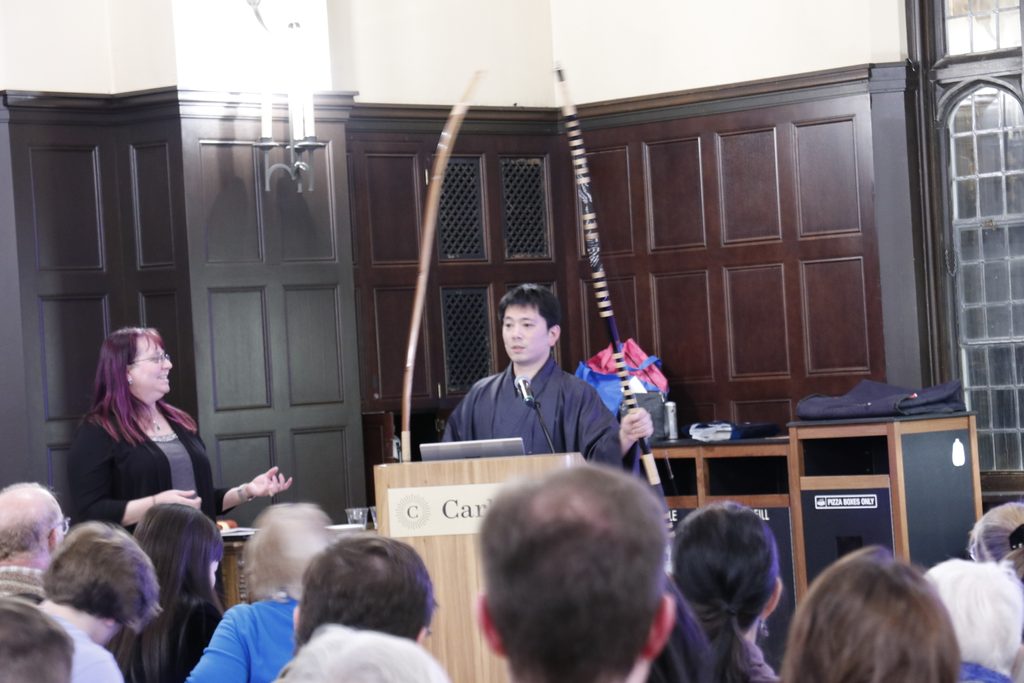 Kiyomoto Ogasawara holds two unstrung kyudo longbows