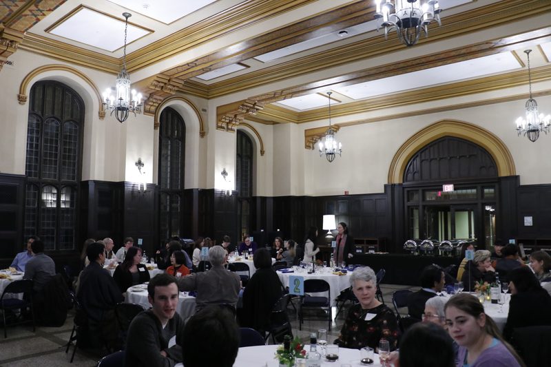 People gather for a community dinner following the lecture.
