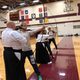 Kyudo Practice. Instructors guide kyudo students with longbows