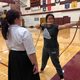 Kyudo Practice. A student draws an arrow as instructor Carly Born looks on