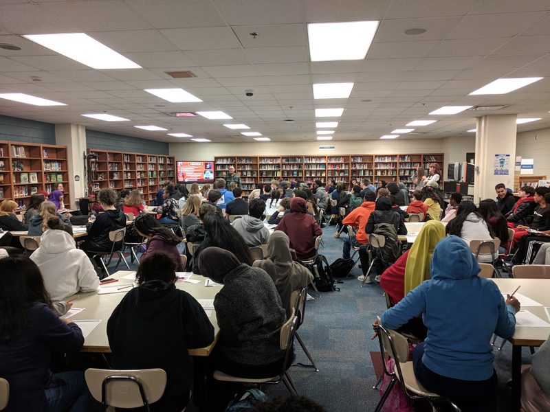 Jimmy Santiago Baca's visit to South High School in Minneapolis. A library is filled with students listening to the poet