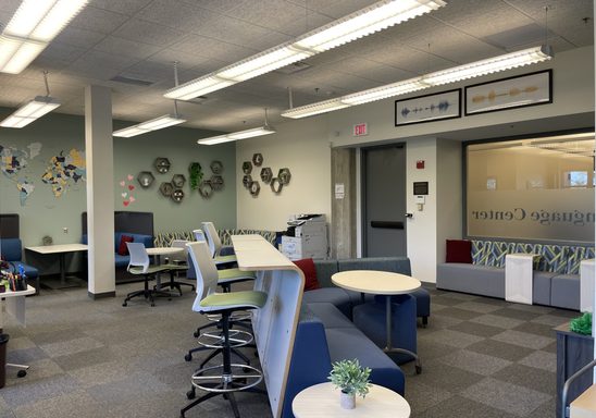 Panoramic view of the Language Center showing comfortable booth and desk seating