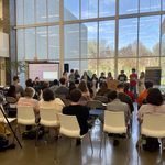 A large group of students perform a poem.