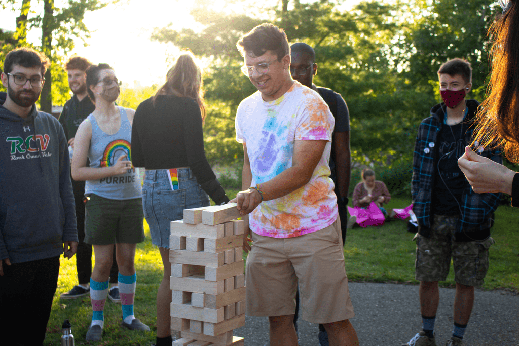 A group of students paying Jenga outside