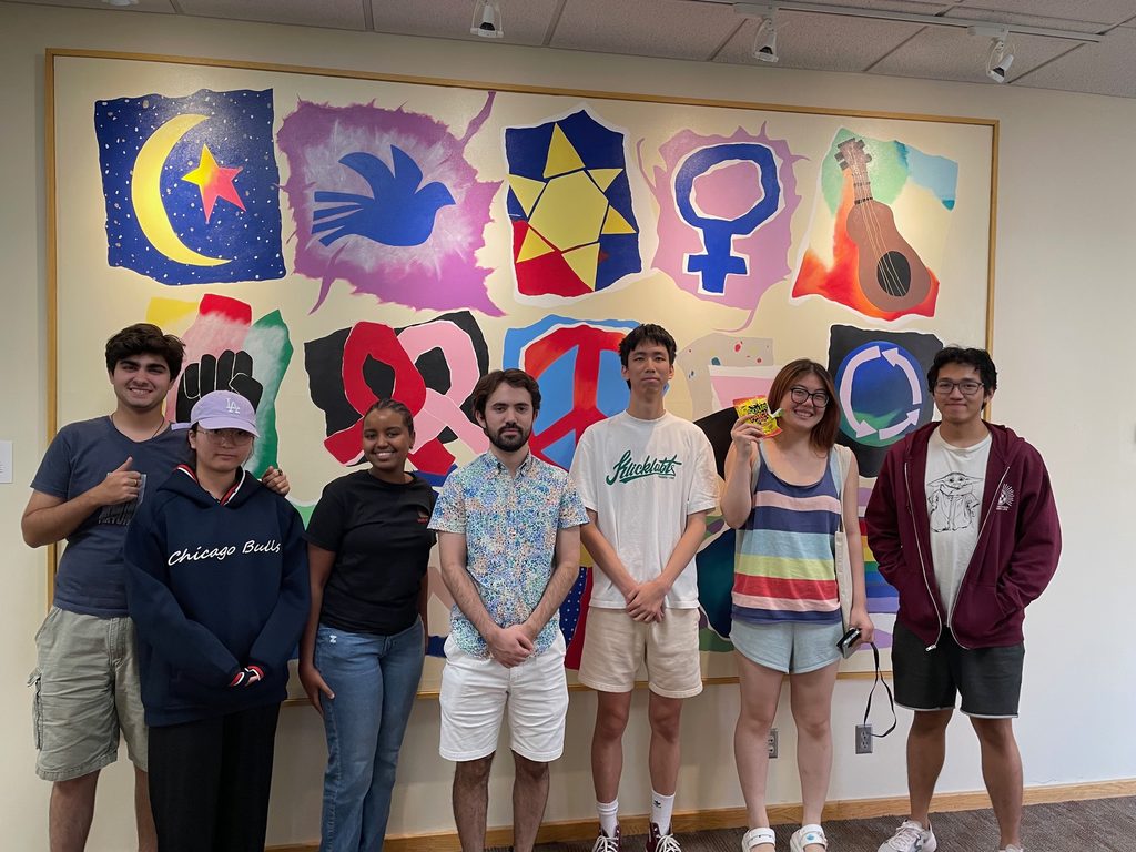 Students in front of colorful paintings