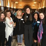 six smiling women pose for a photo