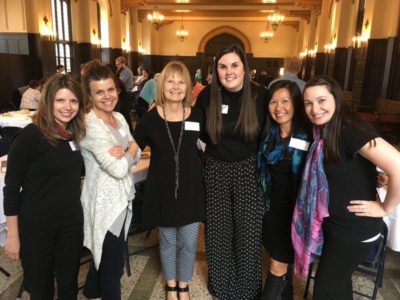 six smiling women pose for a photo