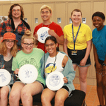 7 students holding Carleton frisbees