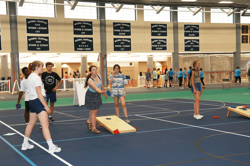 Several students playing corn hole