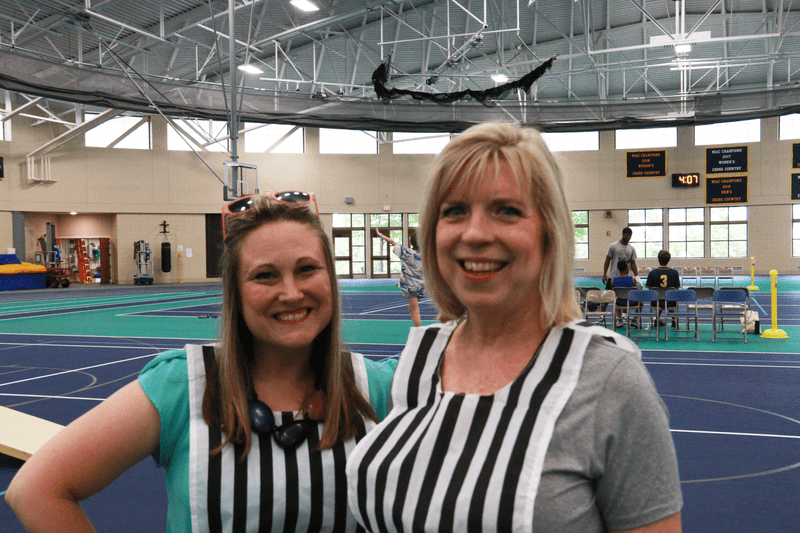 Two referees smiling