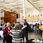 Staff standing and sitting talking with each other