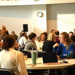 People sitting around watching a presentation