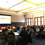People sitting around watching a presentation
