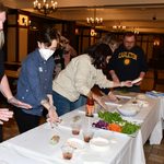 Staff making spring rolls.