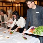 Staff making spring rolls.