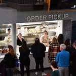 People standing in line at the Sayle Cafe window
