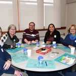 Staff sitting around a table