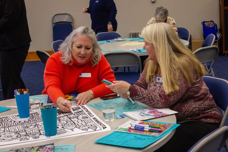 Two people coloring and talking
