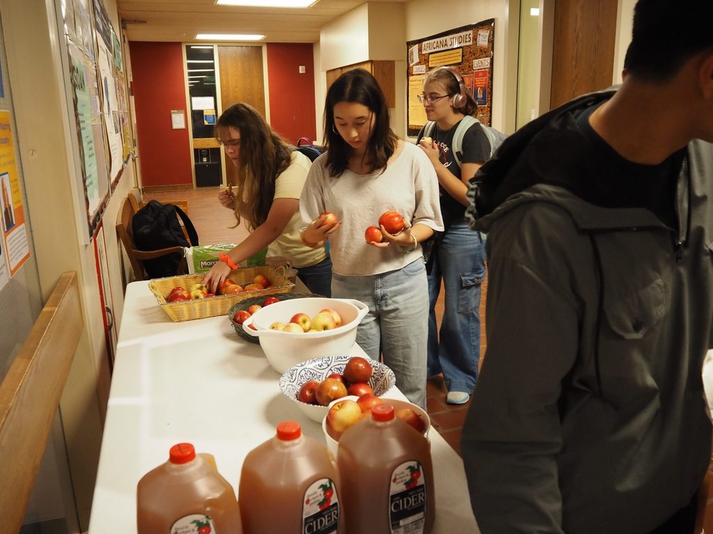 History Junior SDAs Ella Gullickson '26 and Hope Yu '26 selecting apples
