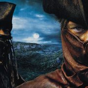 Promotional image from the movie Brotherhood of the Wolf. Two men close to the camera wearing tri-corn hats and leather coats with collars buttoned up to their eyes. The person on the right is looking directly at the camera and wearing a brown coat. The person on the left is oriented 3/4 to the camera and looking into the middle distance between the image viewer and the other man