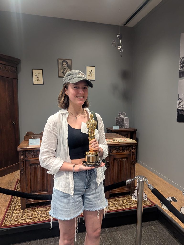 Joella Shearer '26 holding an Oscar statue at the Disney Studio in Los Angeles, California while on OCS program