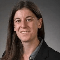 Jocelyn Borchardt '13
Smiling with long dark hair over their right shoulder, wearing a dark collared shirt