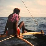 A boy sitting on a boat in Madagascar