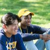 Two students sit in the grass during New Student Week