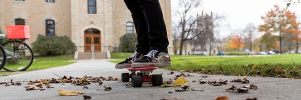 A student skateboards to class