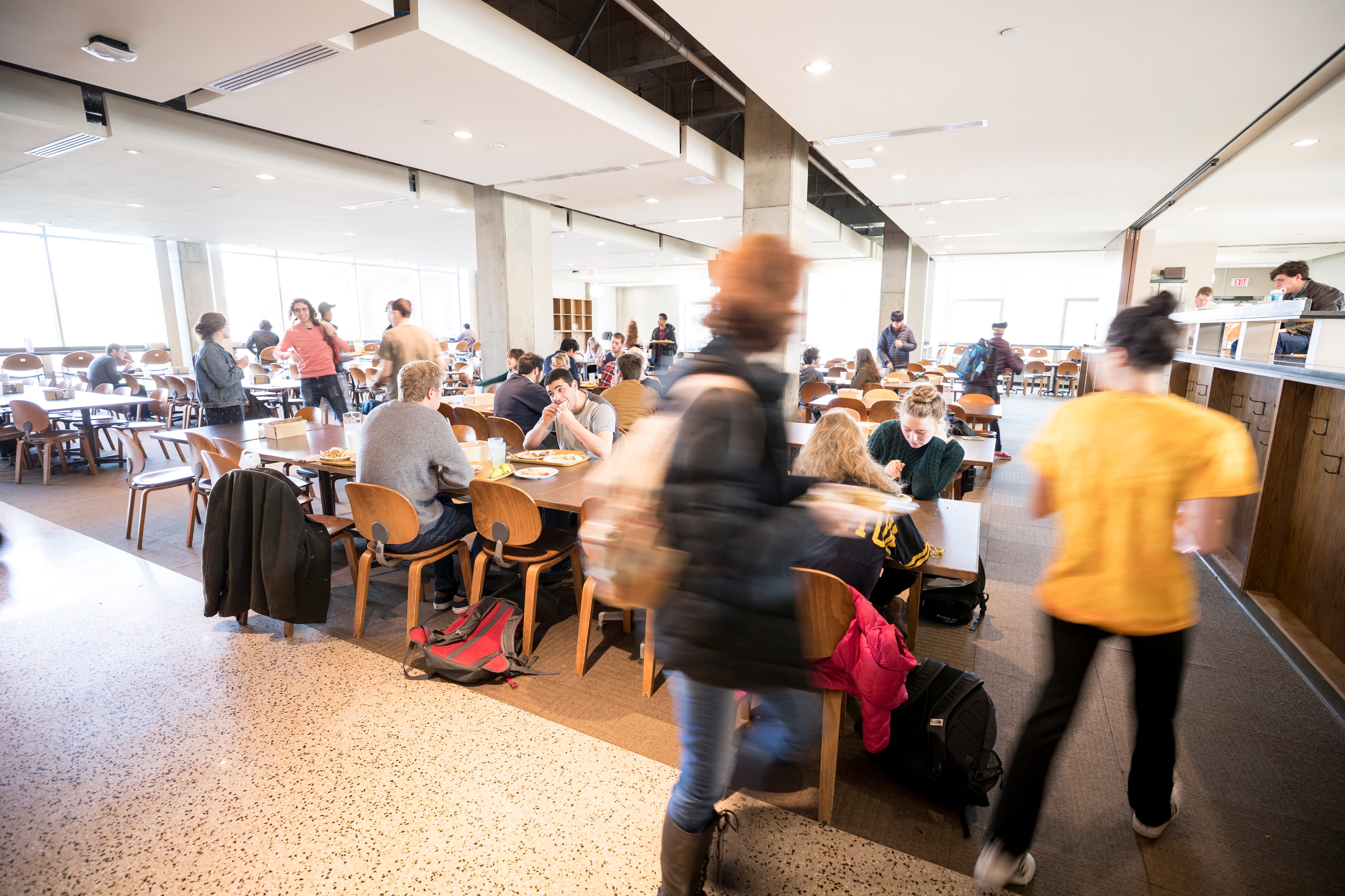 Students eat in a busy dining hall