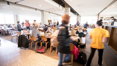 Students eat in a busy dining hall