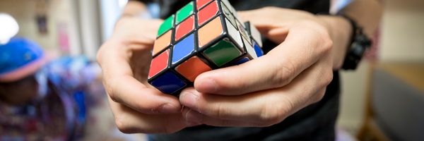A student plays with a Rubik