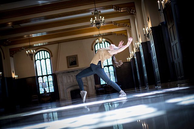 A student dances in the Great Hall