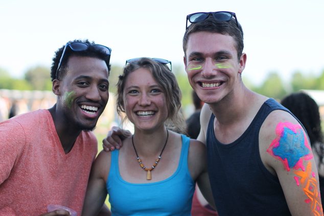 Three students with day-glow face paint hang out at Spring Concert